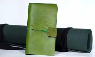 Handcrafted leather journal in leaf green with tree pose engraved.