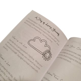 A self-care activity book opened to the page with a Day of Loving Yourself activity.