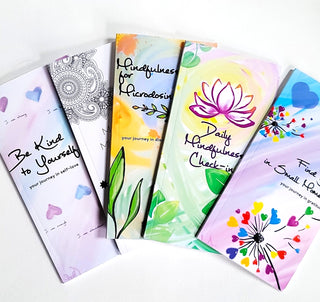 Collection of wellness themed notebooks including gratitude, mindfulness, & self-care.