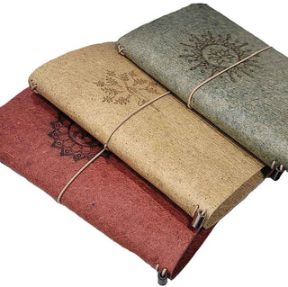 3 vegan leather journals in Tibetan red, Cumin yellow, and Light Indigo made from coconut leather.